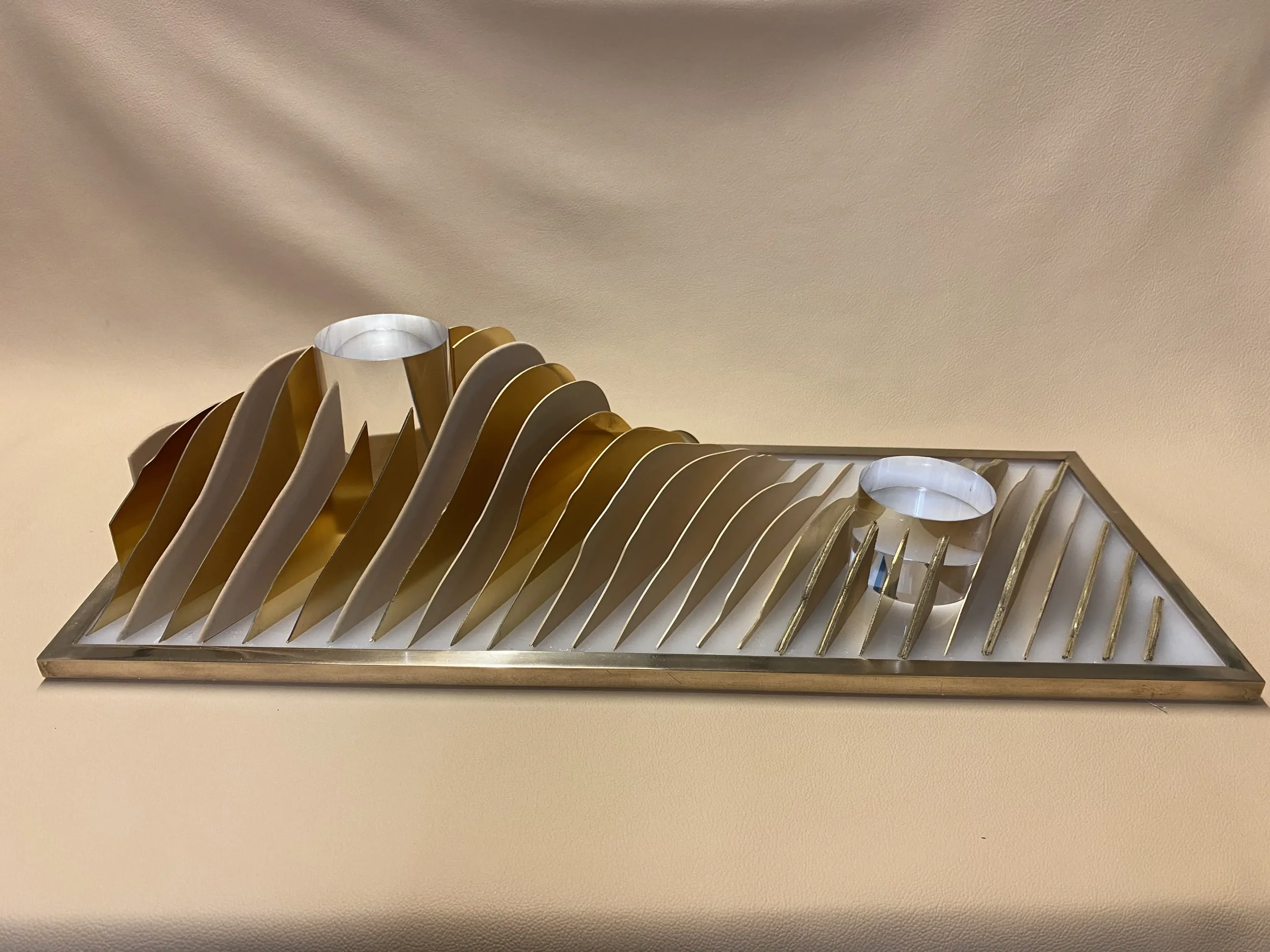 Front-facing image of finished brass perfume display with product holders