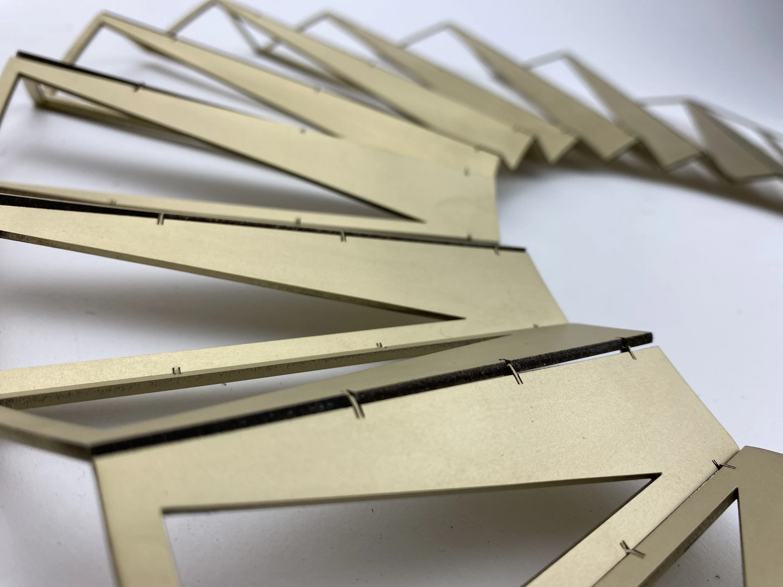 Laser-cut brass panels during fabrication of Helios wall art