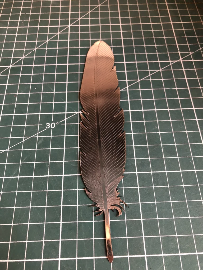 Detailed macro of a metallic feather texture with clean edge finishing