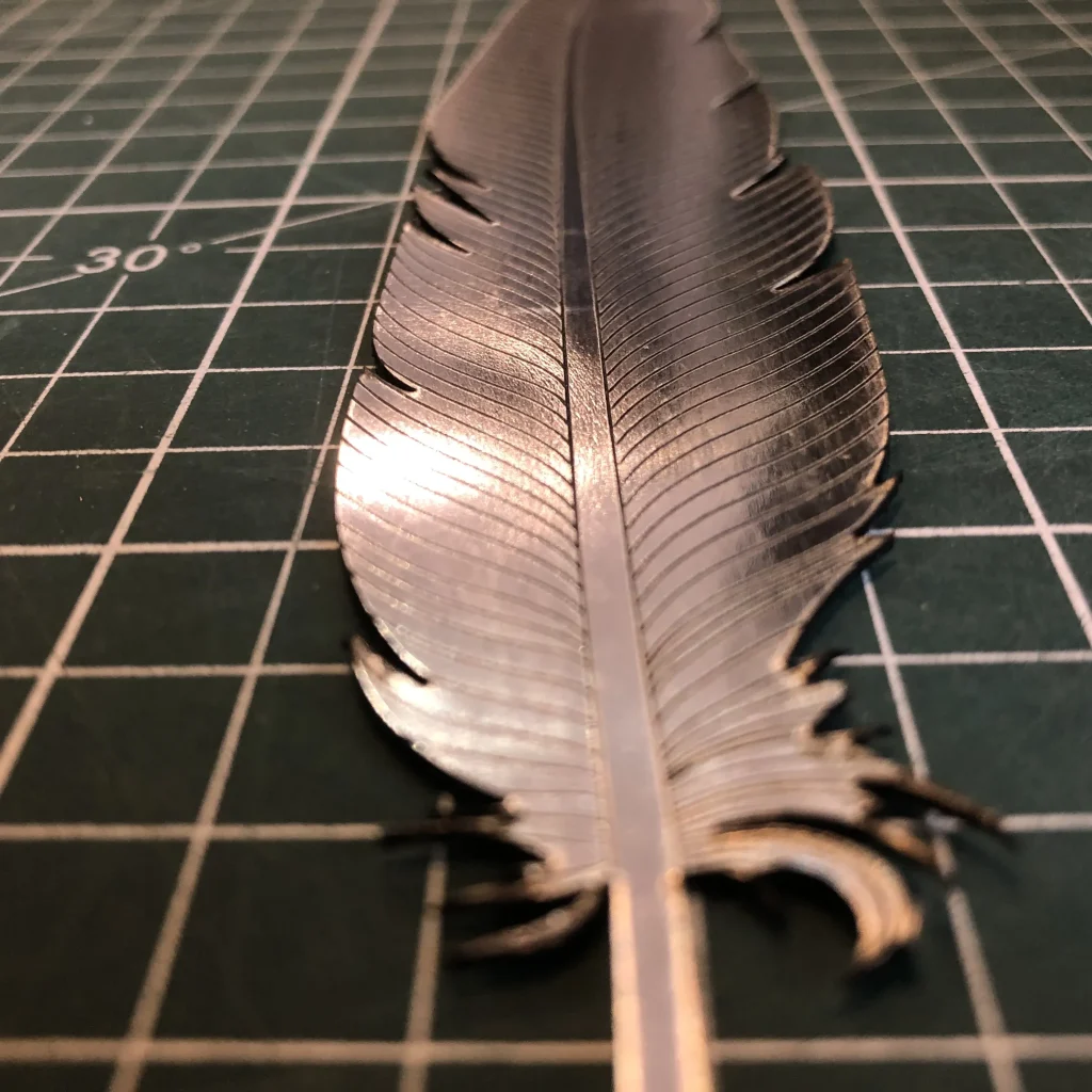 Detailed macro of a metallic feather texture with clean edge finishing