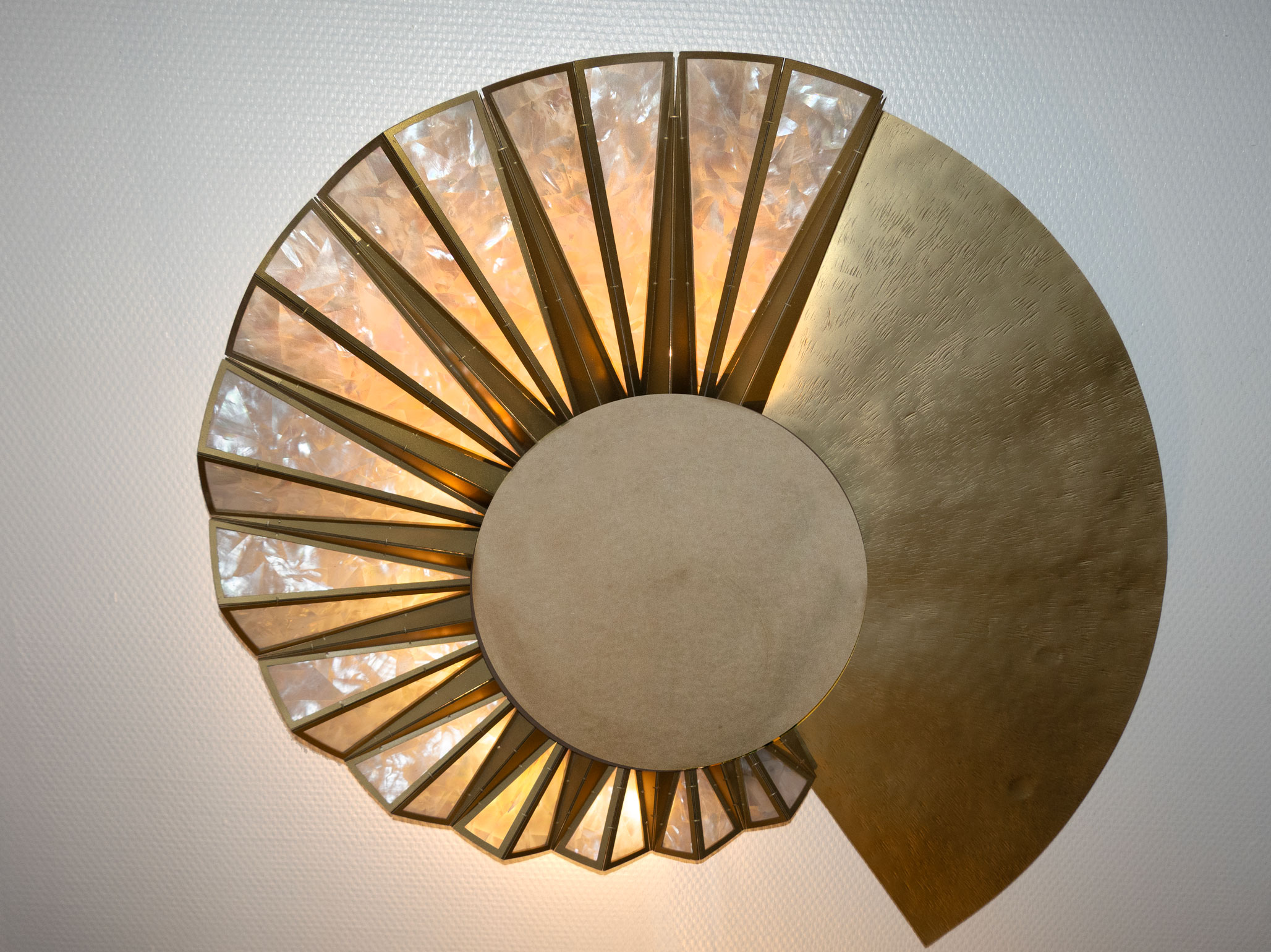 lluminated Helios brass sculpture with mother-of-pearl inlay and central mirror